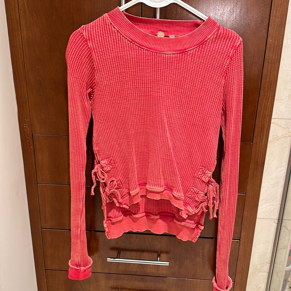 Free People red waffle tee. Worn once.  Adorable side ties and high low hem